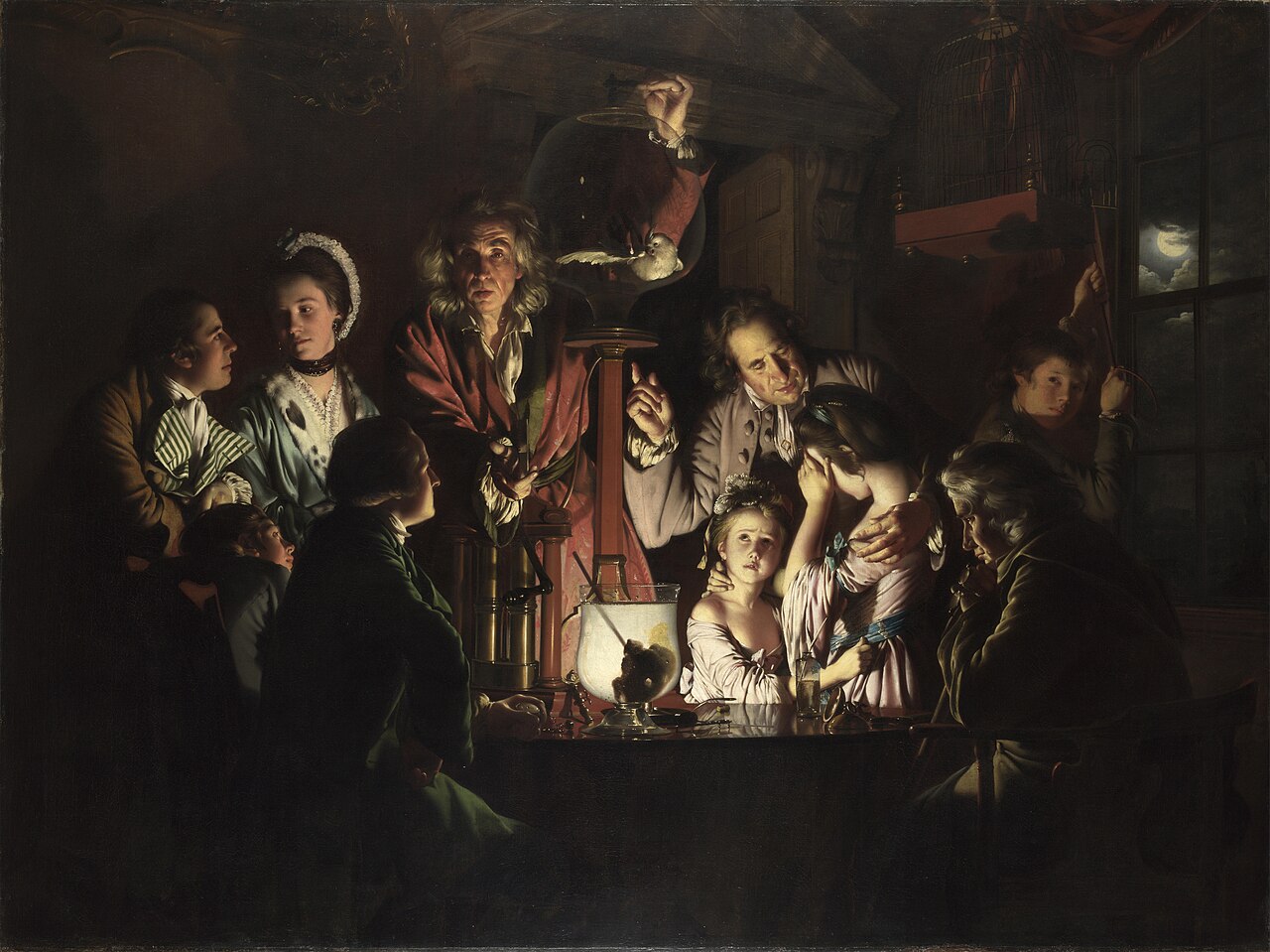 A demonstrator pumps the air out of a glass vessel while a family leans in to see what survives.